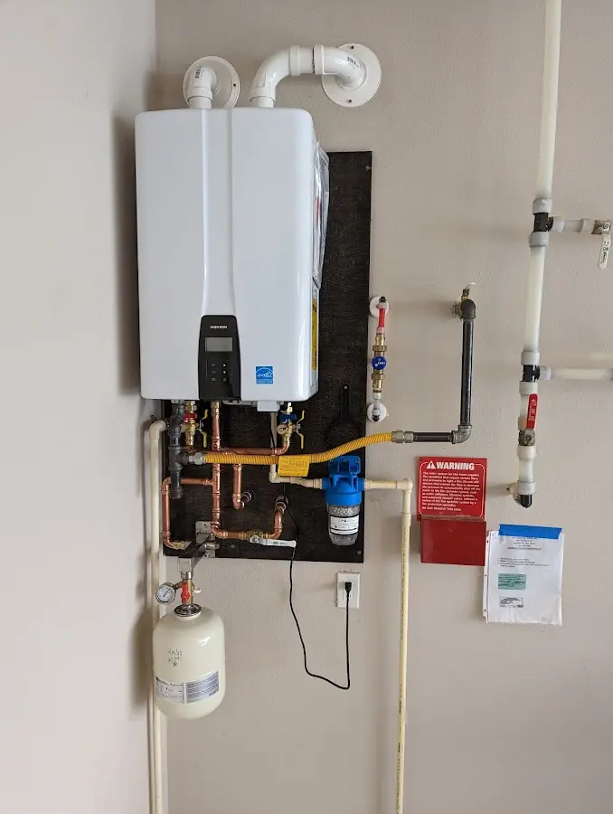 Professional plumber installing copper piping in a Palmerton home